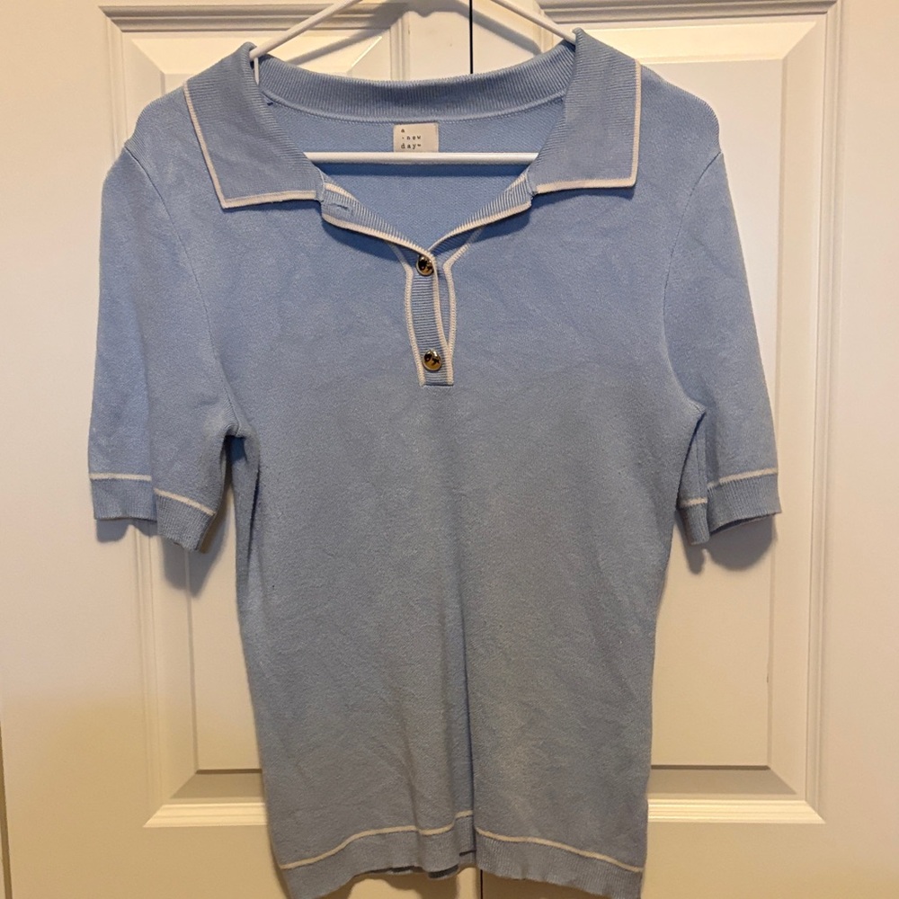 Women’s sky blue polo with gold buttons